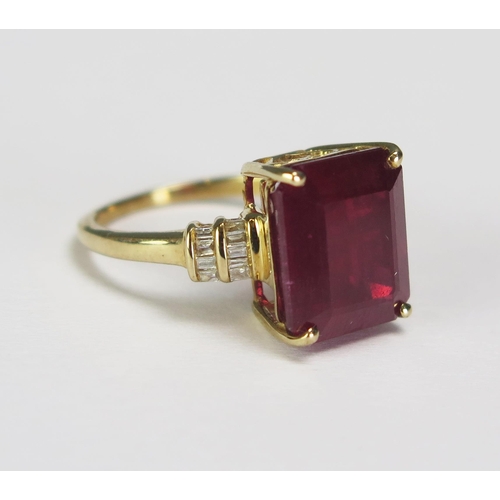 293 - A large emerald cut ruby and diamond set ring in an unmarked yellow metal mount, size K. overall wei... 