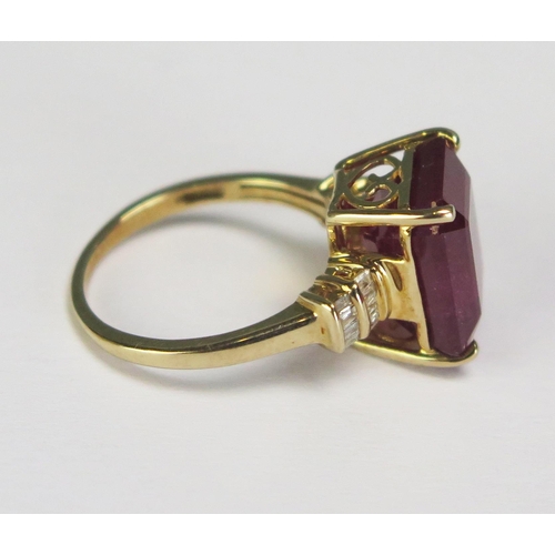 293 - A large emerald cut ruby and diamond set ring in an unmarked yellow metal mount, size K. overall wei... 