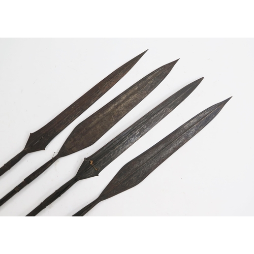 1776 - Four native spears, with double edged blades on slender carved wood shafts, overall lengths 155cm.  ... 