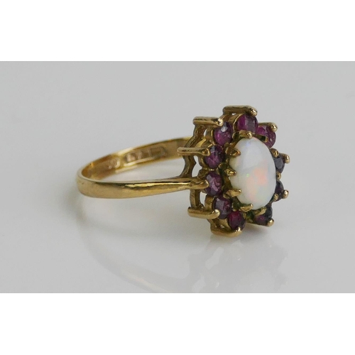 135 - A 9ct Gold, Garnet and Opal Cluster Ring, 12.6x11.2mm head, hallmarked, 2.24g