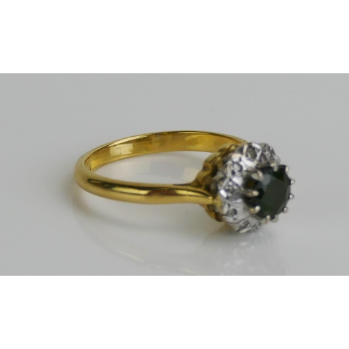 138 - An 18ct Gold, Green Tourmaline and Diamond Cluster Ring, 9.8mm head, size M.5, hallmarked, 4.15g