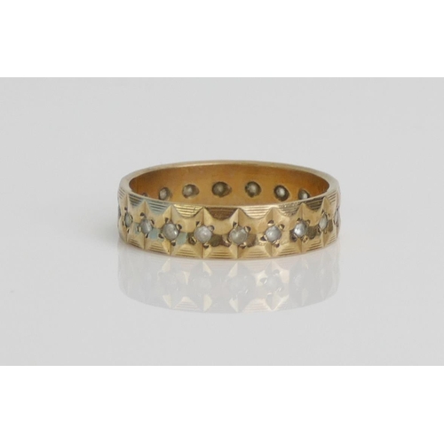 23 - A 9ct Gold and White Stone Eternity Ring, size O.5, hallmarked, 2.83g