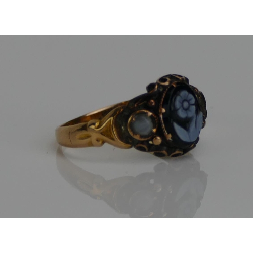 58 - A Victorian Mourning Ring set with a hardstone forget-me-not cameo and in a high carat precious yell... 