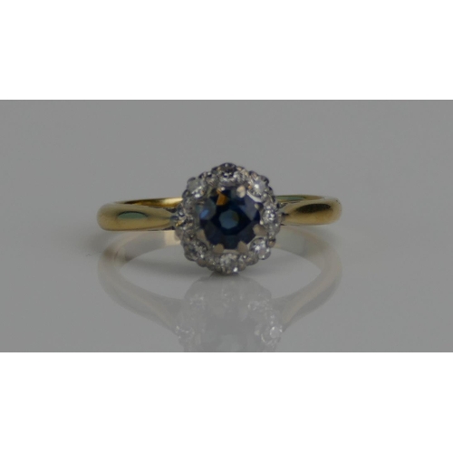 73 - An 18ct Gold, Blue Stone and Diamond Cluster Ring in a platinum setting, c. 14.6mm head, stamped 18C... 