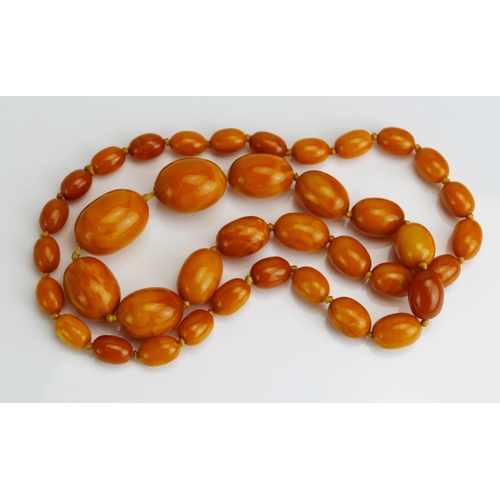 85 - A Baltic Amber Graduated Bead Necklace, 
largest bead c. 32.7x24mm, c. 73cm, 63.14g