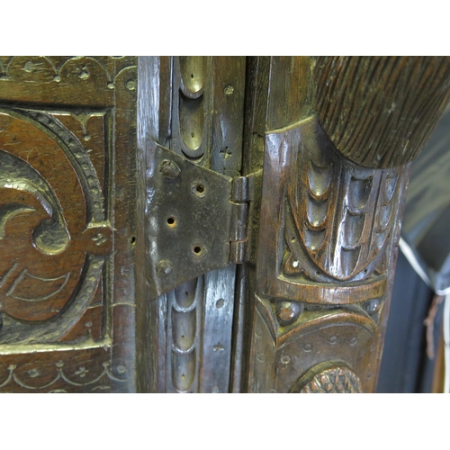 800A - A 17th century carved oak marriage/livery cupboard, with dentil moulded cornice, above a pair of hea... 