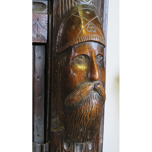 800A - A 17th century carved oak marriage/livery cupboard, with dentil moulded cornice, above a pair of hea... 