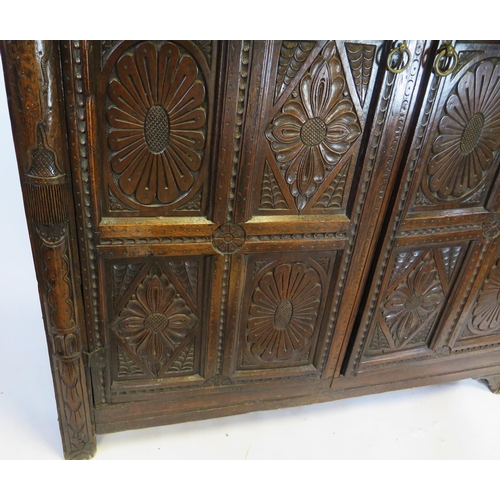 800A - A 17th century carved oak marriage/livery cupboard, with dentil moulded cornice, above a pair of hea... 