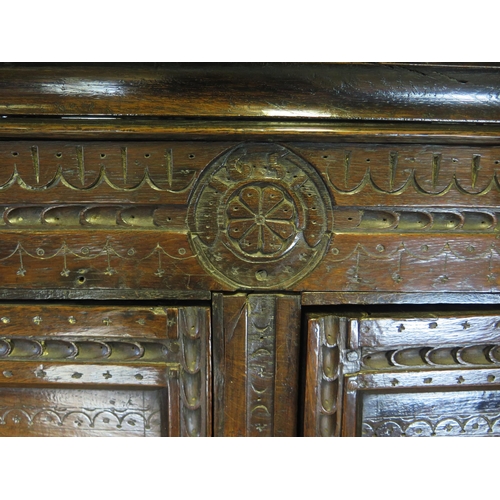 800A - A 17th century carved oak marriage/livery cupboard, with dentil moulded cornice, above a pair of hea... 