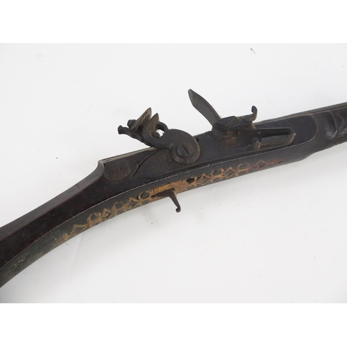 1825A - A North African Kabyle style flintlock gun with 87cm half stocked barrel, steel furniture with bone ... 