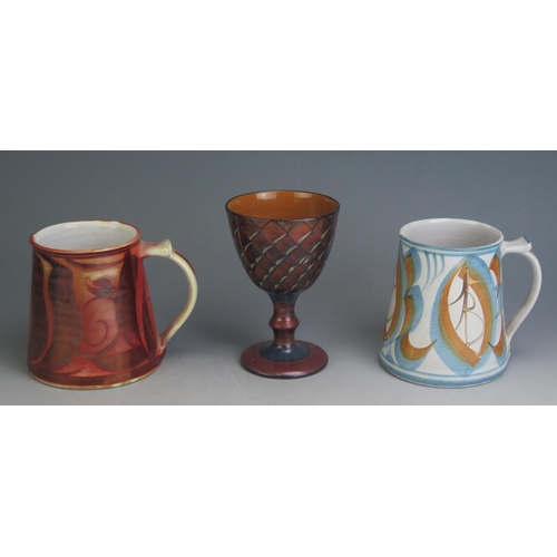 1018 - An Alan Caiger Smith (1930-2020) Studio Pottery Goblet (13.5cm) and two mugs, underglaze painted mar... 