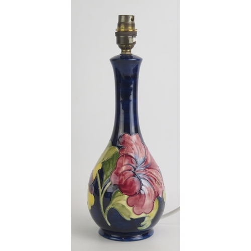 1072 - A Moorcroft pottery table lamp with Hibiscus pattern decoration, overall height 33cm