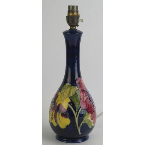 1072 - A Moorcroft pottery table lamp with Hibiscus pattern decoration, overall height 33cm