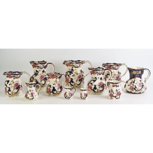 1077 - A collection of Mason's Ironstone china graduated jugs with 'Mandalay' pattern decoration heightened... 