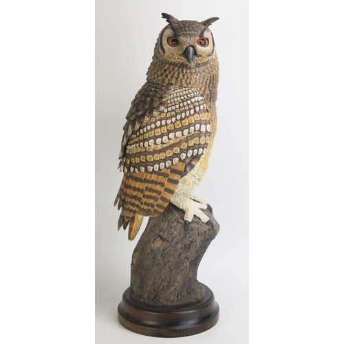 1086 - After Chris Farrant, a resin model of an eagle owl, mounted on a polished wood base, 52cm high.