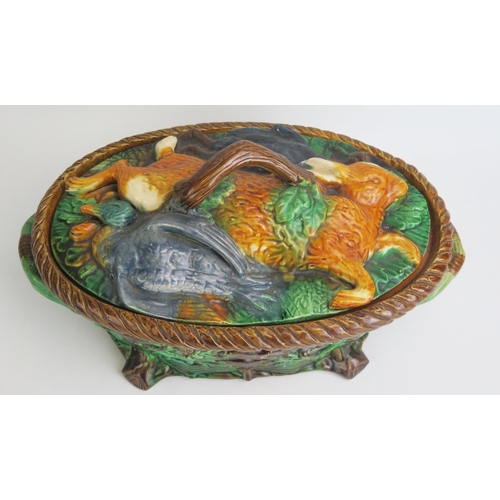 1087 - A Victorian style majolica game dish and cover of oval outline the cover decorated with dead game, t... 