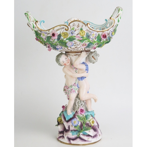 1093 - A continental porcelain pedestal basket, of boat-shaped outline with encrusted floral decoration, su... 