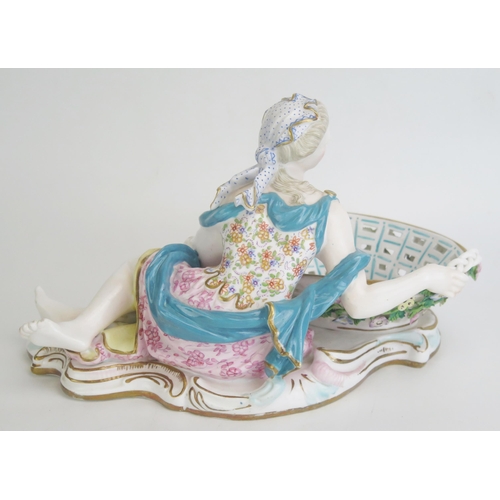 1094 - A continental porcelain figural sweetmeat basket, modelled as a classical lady by a pierced basket e... 