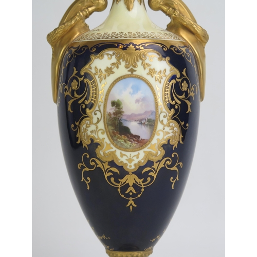 1096 - A Coalport porcelain vase of neo classical form, with two panels painted with waterfall scenes, to a... 