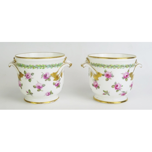 1098 - A pair of Sevres porcelain cachepots, of cylindrical form with painted rose pattern decoration heigh... 