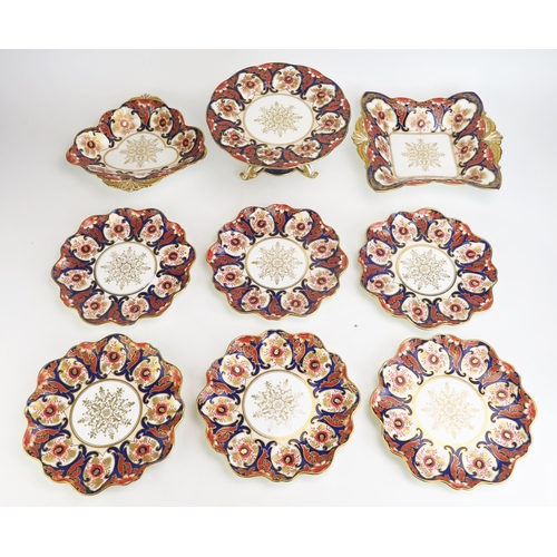 1099 - An Aynsley china part fruit service, decorated in the Imari palette, includes comport, two serving d... 