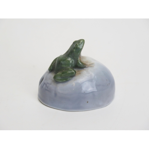 1100A - A Royal Copenhagen porcelain model of a frog seated on a rock 4cm high