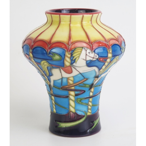 1107 - A Moorcroft pottery vase with merry-go-round decorated vase, signed E Bossons 95/350, 14cm high.