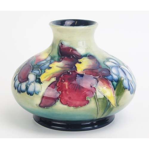 1110 - A Moorcroft pottery vase of compressed circular form, with Orchid and spring flower pattern decorati... 