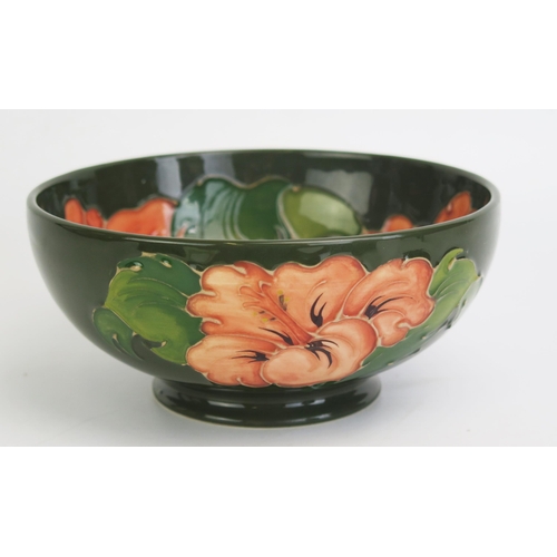 1112 - A Moorcroft pottery bowl with Hibiscus pattern decoration, 16cm diameter.