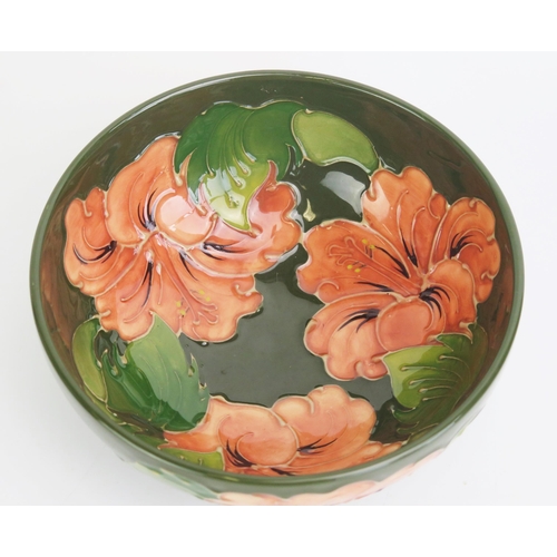 1112 - A Moorcroft pottery bowl with Hibiscus pattern decoration, 16cm diameter.