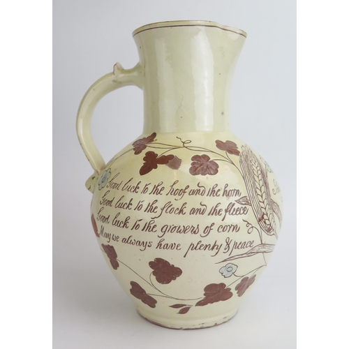 1131 - Edwin Beer Fishley (1836-1912) a Fremington pottery Harvest Jug, decorated in pale yellow slip with ... 