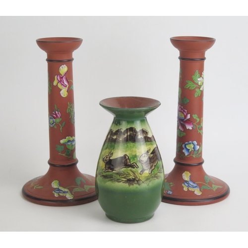 1137 - A pair of Wedgwood terracotta candlesticks with enamel floral decoration, 23cm high, together with a... 