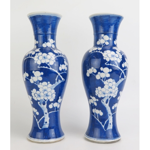 1146 - A pair of Chinese porcelain vases of baluster form with flared rims with blue and white prunus decor... 