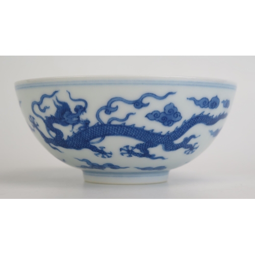 1147 - A Chinese blue and white rice bowl, with blue and white dragon decoration, seal mark to base, 12.5cm... 