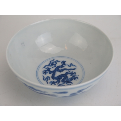 1147 - A Chinese blue and white rice bowl, with blue and white dragon decoration, seal mark to base, 12.5cm... 