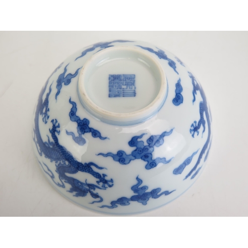 1147 - A Chinese blue and white rice bowl, with blue and white dragon decoration, seal mark to base, 12.5cm... 