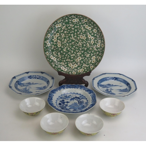 1157 - A Chinese plate with green and white prunus decoration, hand painted with four character mark to the... 