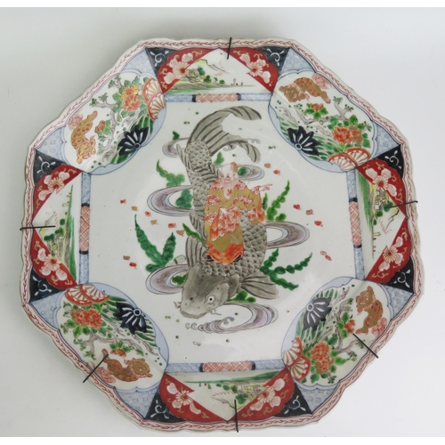 1159 - A large Imari porcelain charger of octagonal outline, the centre decorated with an immortal standing... 