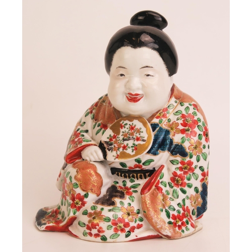 1161 - A Japanese porcelain figure of a seated lady holding a fan decorated in the Imari palette, 17cm high... 