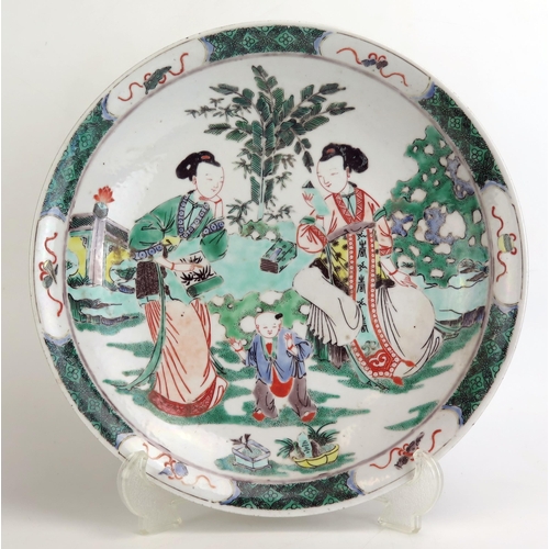 1163 - A famille verte porcelain dish, decorated with figures in a garden landscape, 29.5cm diameter,