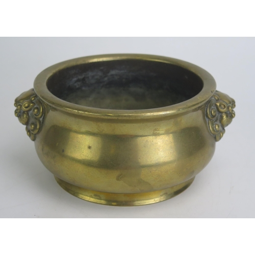 1171 - A Chinese bronze censer, of plain circular form, with dragon mask handles, bears six character Xuand... 