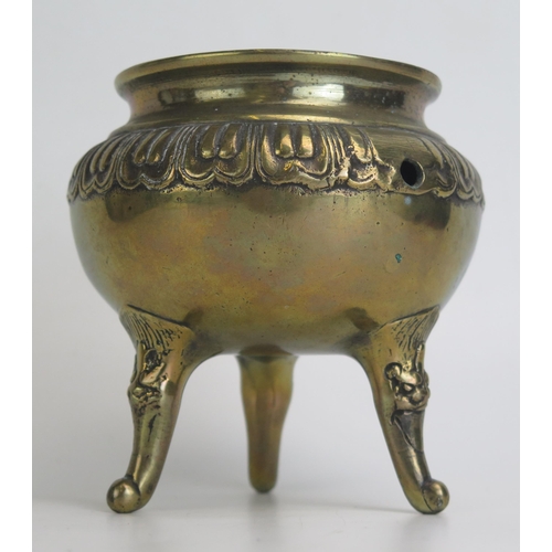 1173 - A Chinese bronze tripod censer, of circular form raised on three swept legs. 13cm diameter.