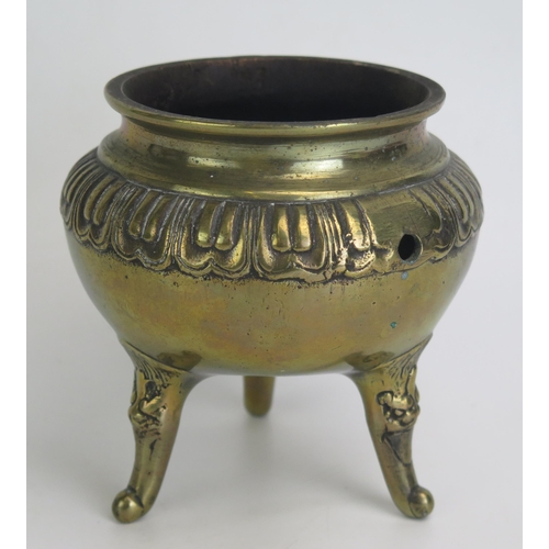 1173 - A Chinese bronze tripod censer, of circular form raised on three swept legs. 13cm diameter.