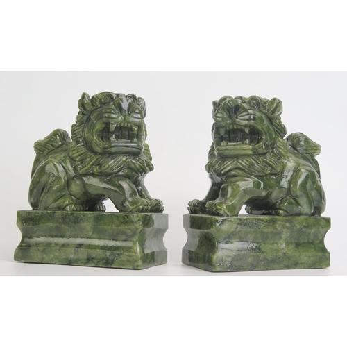 1174 - A pair of Chinese jade style figures of temple lions, mounted on rectangular plinth bases12cm high, ... 