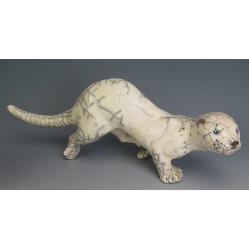 1205 - A Paul Jenkins Style Studio Pottery Raku Model of an otter (42cm long, incised mark and dated 2004) ... 