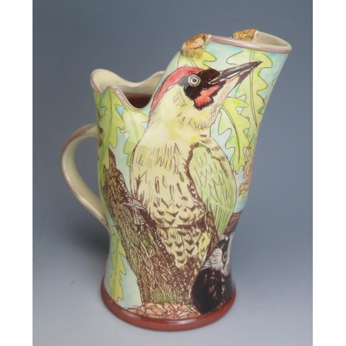 1206 - A Near Pair of Studio Pottery Terracotta Jugs, one decorated with a red squirrel and green woodpecke... 