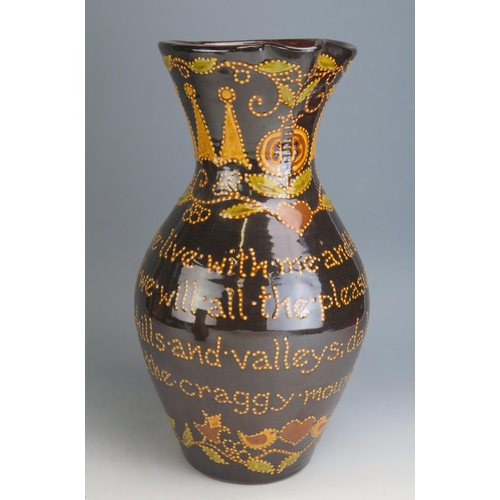 1208 - Carole Glover _ A Large Terracotta Motto Ware Jug with scroll handle, 40cm high, incised marks