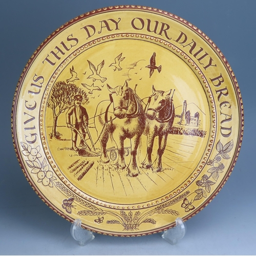 1212 - A Harry Juniper Terracotta 'Give Us This Day Our Daily Bread' Plate, 33cm diam.