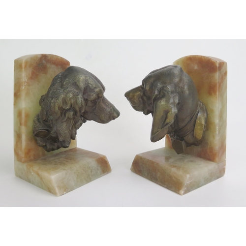 1244 - A pair of bronzed spelter and onyx book ends modelled in the form of spaniel's heads, 20cm high.