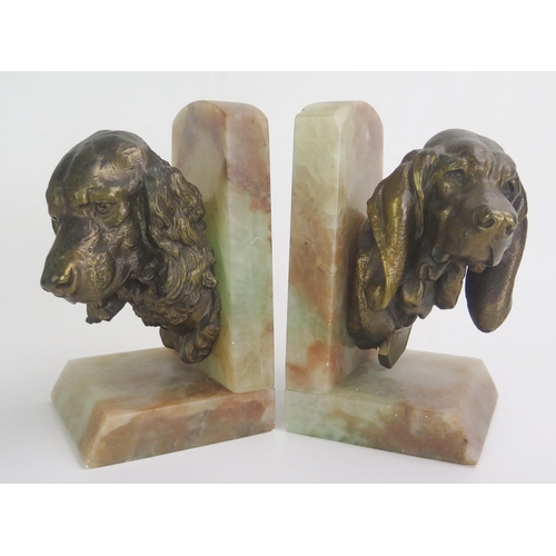 1244 - A pair of bronzed spelter and onyx book ends modelled in the form of spaniel's heads, 20cm high.